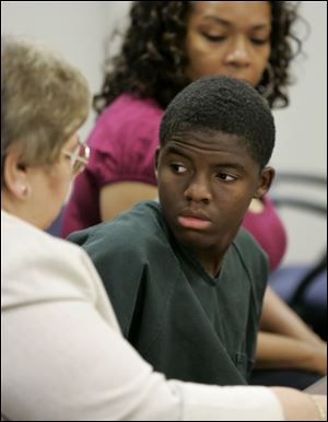 Dailahntae Jemison, 15, appears in Lucas County Juvenile Court with his lawyer, Joanne Rubin, left, and his foster mother, Twanda Harris. He is charged with murder in Robert Brundage's death.