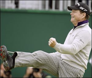 Tom Watson celebrates as he rolls in a 45-foot putt on the 18th green to take a share of the lead.
