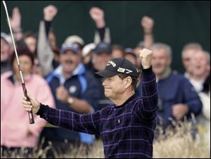 Tom Watson celebrates sinking a 30-foot birdie putt on the 16th hole. The 59-year-old has the lead heading into the final day.