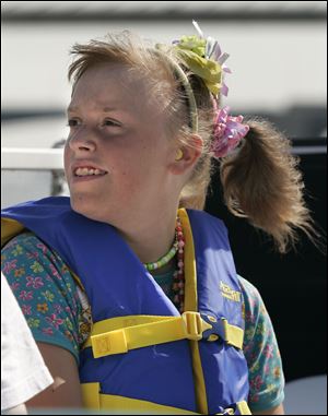 CTY boatride21p  07/20/09  The Blade/Dave Zapotosky Caption: Chelsea Czerniejewski, 15 of Toledo, takes in the sights during a boat ride on the Maumee River, in Toledo, Ohio, put on by Safe Kids Greater Toledo, Monday, July 20 2009.  The ride was the fourth of sixth for special needs children this summer.  The rides are free to special needs children and a caregiver.  (Call or email Pam Proudfoot, coordinator of community outreach for Toledo Children's Hospital to register  419.291.8487 or pamela.proudfoot@promedica.org.  There are two more boat rides in August) Summary: Safe Kids Greater Toledo (lead agency: Toledo Children's Hospital)is hosting a series of one-hour boat rides for children with special needs. The children and their caregivers will learn about water  safety and experience a one-hour boat tour of the Toledo Port. The program is supported by a grant from the Ohio Department of Natural Resources Division of Watercraft.