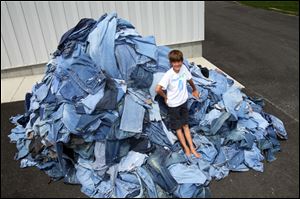 The 1,055 jeans Erek Hansen gathered will become insulation. With his aid, National Geographic Kids magazine set the Guinness World record for the largest collection of clothes for recycling.