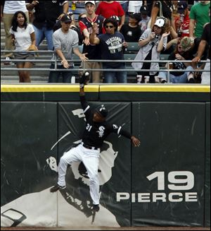 Former Mud Hen DeWayne Wise goes above the fence to save the perfect game in the ninth inning.

