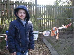 Alex is proud of the clothesline sculpture he made at Mulberry Bush School.