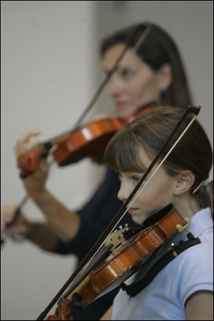 Waterville residents Beth Hyder, rear, and her daughter, Claire Stoll, take classes together from Cheryl Trace.