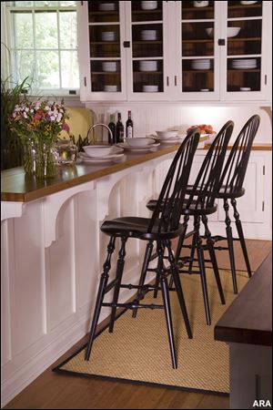 Photo courtesy of Caperton Furnitureworks. Just like the old masters, the spindles on this cherry counter stool run all the way through the bows and are secured with wood wedges.