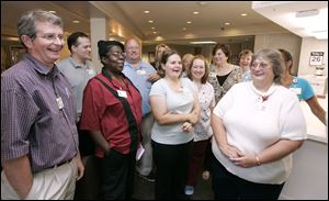 A group of 24 employees at Oakleaf Village of Toledo won $250,000 in Tuesday night s Mega Millions drawing. Front row, from left, are David Moyer, Gussie Wilson, Alison Ostrosky, and Jan Krueger.