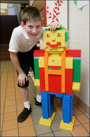 NBRW gesu09p  09/03/09  The Blade/Dave Zapotosky Max Minor, a West Toledo fifth-grade student at Gesu School, poses with the robot he made from Legos, Thursday, September 3, 2009. The robot is a 