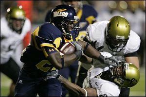 Toledo's DaJuane Collins tries to elude Colorado's Cha'pelle Brown during the first quarter.
