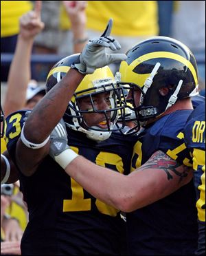 Michigan wide receiver Greg Mathews, left, celebrates his game-winning touchdown with offensive lineman Perry Dorrestein.