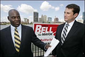 Toledo mayoral candidate Mike Bell, left, with associate professor Steven Cady of Bowling Green State University discusses an assessment to find what's working in Toledo and what's not.