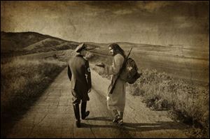 Michael Belk said he titled this photo ‘The Second Mile,' after Matthew
5:38-41, with Jesus walking alongside a Nazi and carrying the soldier's
rifl e and backpack to illustrate forgiveness.