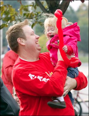 Slug:  CTY walk05p                      Date 10/4/2009           The Blade/ Amy E. Voigt                   Location: Toledo, Ohio  CAPTION:   Shane Long, from Toledo, holds his daughter Avary (cq) Long, 18 months, before the family walks in the Down Syndrome Association of Greater Toledo Buddy Walk in celebration of National Down Syndrome Awareness Month on October 4, 2009.