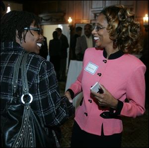 Marguerite Benson, left, greets Andrea Price.