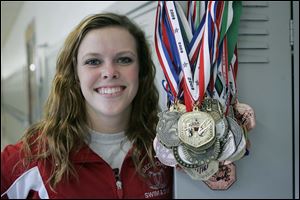 Cheyenne Cousineau has collected plenty of medals. Last year she set a
Michigan record with 483.80 points to win her second straight state title.