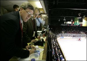 Larry Hanudel, left, and Toby Oothoudt keep track of the action during a game at the Sports Arena. Both will be among the off-ice officials who will work Walleye games at the Lucas County Arena.