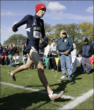 St. John's Jesuit runner Greg Turissini won the boys individual crown with a time of 15:57.30 after finishing in second place last year and fifth as a freshman. The Titans won the team crown after St. Francis de Sales had a runner disqualified.