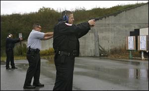 Chief John Betori, right, Danny Jones, center, and Luis Munguia sharpen their shooting skills on the range.