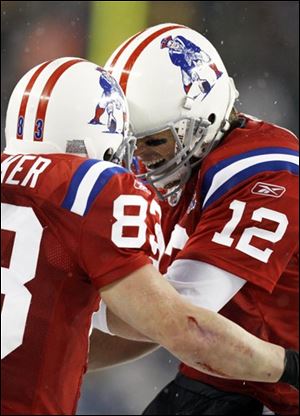 New England Patriots quarterback Tom Brady (12) celebrates a touchdown with wide receiver Wes Welker during the second quarter of a NFL football game at Gillette Stadium in Foxborough, Mass. Sunday, Oct. 18, 2009.