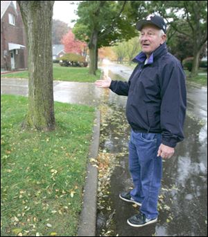 Chuck Horvath points out the tree at Kingsmoor and Eastbrook drives where a pickup was stopped with the body of Ysidro Mora. 