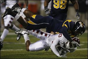 The Rockets' Barry Church rocks Delano Green Saturday night. In the first quarter, UT's senior safety blocked an extra-point attempt — his third block in two games.
<br>
<img src=http://www.toledoblade.com/graphics/icons/photo.gif> <font color=red><b>VIEW</font color=red></b>: <a href=