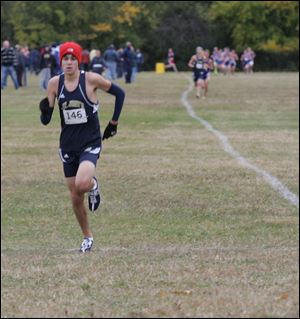 Greg Turissini of St. John's heads to the finish line. His first-place finish led the Titans to their sixth straight district title.
