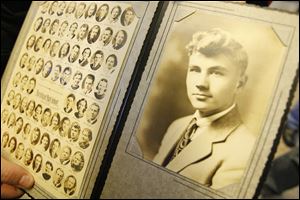 Morgan Ford displays pictures of himself as a high school senior and of his class of 1938. Mr. Ford attended Sunday's community open house for Burnham High School alumni.