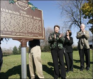 CTY haroun02p  Members of the Harroun family aid in the unveiling of a marker commemorating a previous generation's role in the Underground Railroad, at the site of a barn used to hide freedom seekers, on the campus of Flower Hospital in Sylvania, Ohio. From left, blocked by marker, is Tim Scovic, now  of Chicago, and son of Janice Harroun Scovic, of Sylvania, second from left, with her sister Diane Huss, now of Lasalle, Michigan; Alan Sattler, president of Flower Hospital. The Sylvania Area Historical Society and Ohio Historical Society unveil a new historical marker to recognize the role of the Harroun Family and the Harroun Barn in the Underground Railroad in Sylvania, Ohio on November 1, 2009.  The Blade/Jetta Fraser