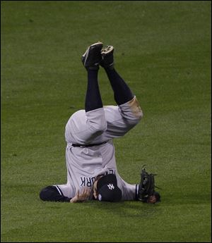 Johnny Damon of the Yankees goes tumbling after failing to catch a pop fly by Shane Victorino Sunday night in Philadelphia.