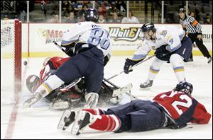 Jonathan Carlsson (4) scores over Wings goalie Ryan Nie as Kevin Rankin (86) takes out Darryl Lloyd (72).
