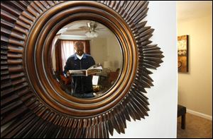 Slug:CTY tour08p                         Date 11/7/2009           The Blade/ Amy E. Voigt                   Location: Toledo, Ohio  CAPTION:  Johnny Reese Sr. looks at the guide to see which home he will hit next while being reflected in a mirror at 174 Kingswood Trail during the Tour Toledo Preview of Homes tour that was open to the public on November 7, 2009.