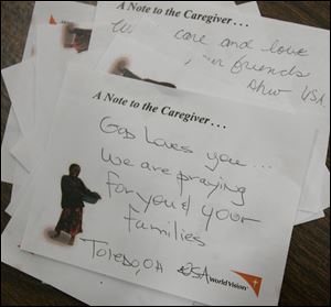 CTY kits23p  11/22/2009    Blade Photo/Lori King  Hand-written notes of encouragement are put in each of the 200 volunteer caregiver kits assembled at St. Joseph Catholic Parish Community Center Gymnasium in Maumee, OH.