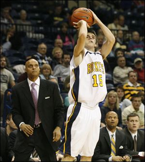 Coach Gene Cross keeps a close eye on Stephen
Albrecht as he drills a 3-pointer.