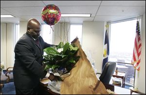 Mayor Mike Bell opens a gift from the Woodward High School Hall of Fame Alumni in his office. The building's maintenance staff spent some time getting the mayoral suite ready for its new resident.