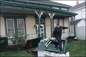 A Eureka Police officer walks across a damaged porch of a California Street house that was knocked off its foundation after Saturday's earthquake. A magnitude-6.5 earthquake struck off the coast of Northern California Saturday afternoon Jan. 9, 2010 shaking buildings, knocking out power in several coastal communities and leaving a trail of broken windows and dishes south of the Oregon border. 