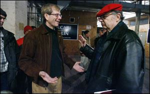 Jon Stainbrook, left, speaks with Michael Griswold after last night's meeting of the Lucas County Republican Party executive committee that backs Mr. Stainbrook. Leadership of the party remains under dispute.