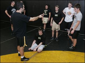Perrysburg coach Matt Boggs holds practice. Nick Hyndman always starts practice on his knees
and has been working with Boggs on strength training and ways to defend himself in matches.