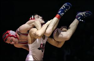Oak Harbor's Ian Miller takes down Wauseon's Austin Kutzli during the 145-pound title match.
