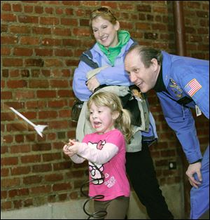 CTY frozen17p    01/16/2010       The Blade/Lori King  Grace Pizza, 4, fires off a rocket with the assistance of Reed Steele, the director of the Challenge Learning Center, during Frozentoesen activities at the Toledo Zoo.  Watching is her mom, Tracy Pizza.