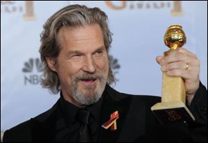 Jeff Bridges poses with the award for best actor in a motion picture drama for 'Crazy Heart'.