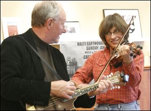 Tom Barden and Cindy Lipman perform with the Toledo band Old State Line during a fund-raiser at Caffeini's Coffee, 1471 Secor Rd., near the University of Toledo campus to benefit Haitian relief efforts.