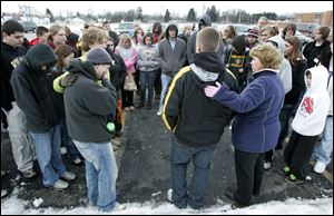 Counselor Jodi Hess puts her arm around Northview High School freshman Ben Cannon, 15, at left, and school psychologist Kim Pawlicki puts her hand on the back of another teen at a memorial.
<br>
<img src=http://www.toledoblade.com/assets/jpg/TO66067417.JPG> <b><font color=red>VIEW: </b></font color=red> <a href=