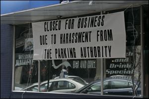 A sign in the window of Hat Trick Bar and Grill, 319 North Superior St., gives owner Ahmad Mahmoud's
reason for temporarily shutting the downtown business.