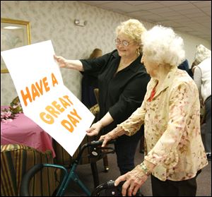 Slug:  CTY edna26p                    Date 1/25/2010           The Blade/ Amy E. Voigt                    Location: Toledo, Ohio  CAPTION:   Diane Woodard, left, Resident Council President, shows  Edna Sandys (cq) , right, a special birthday card during her 101st. surprise birthday party at Lakewood Apartments on January 25, 2010.