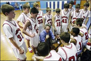 The young Bobcats gather around to get directions from coach Steve Stoller.