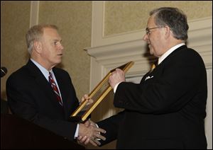 Gov. Ted Strickland, left, presents The Blade president and general manager Joe Zerbey with a proclamation for its 175th year of publishing Wednesday, Feb. 10, 2010, in Columbus, Ohio.<br>
(SPECIAL TO THE BLADE/JAY LAPRETE)<br>
<img src=http://www.toledoblade.com/graphics/icons/photo.gif> <font color=red><b>VIEW</b></font>: <a href=