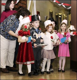 Teacher aide Julie Koralewski guides, from left, Brie Sensenstein, Ben Kleparek, Kenley Koval, and Lena Flores during the wedding ceremony of Q and U at Crissey Elementary School.