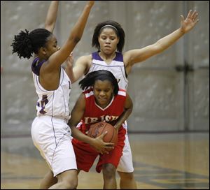 Waite's Miriah Haynes, left, and Courtney Jackson surround Central Catholic's Brianna Rogers on defense.