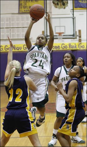 Start's Charon Sweeney shoots over Notre Dame's Demy Whitaker (12) in the first quarter. Sweeney led the Spartans with 11 points.
