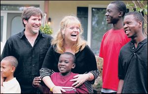 Aaron and Jackie Frisch with children Mikail, left, Charlie, Max, and Joe in 2008 during a ceremony outside their new
‘Exreme Makeover: Home Edition' house in Toledo.