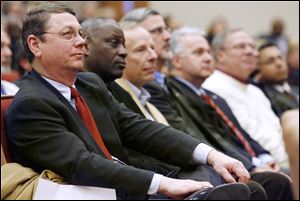 From left, Toledo City Councilmen Rob Ludeman, Michael Ashford, Tom Waniewski, Steven Steel, George Sarantou, D. Michael Collins, and Adam Martinez listen to Mayor Bell's address.
